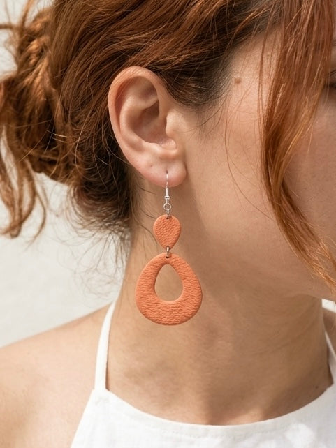 Warm clay and coral teardrop drop earring, handmade polymer clay, worn on ear