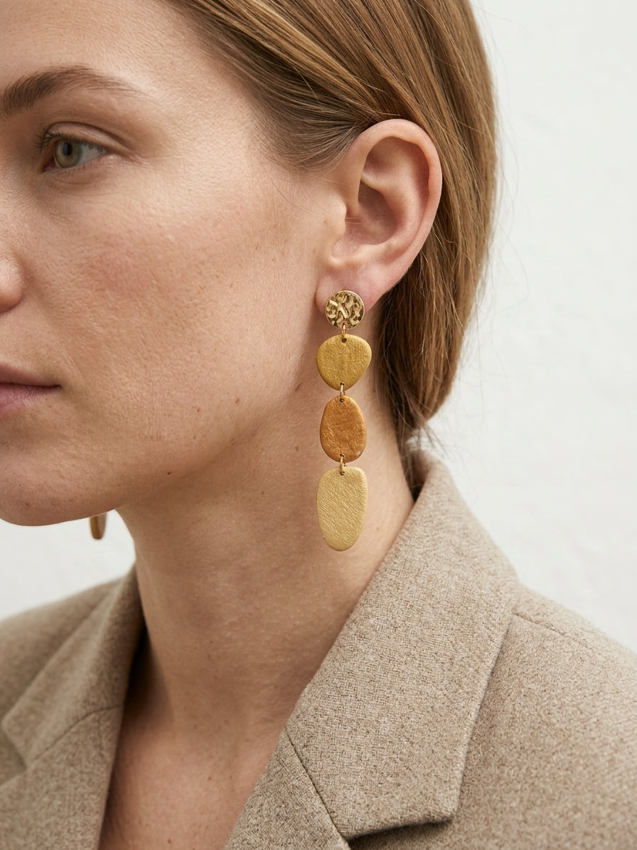 Handmade polymer clay drop earrings in hammered gold and amber tones — Mariamné