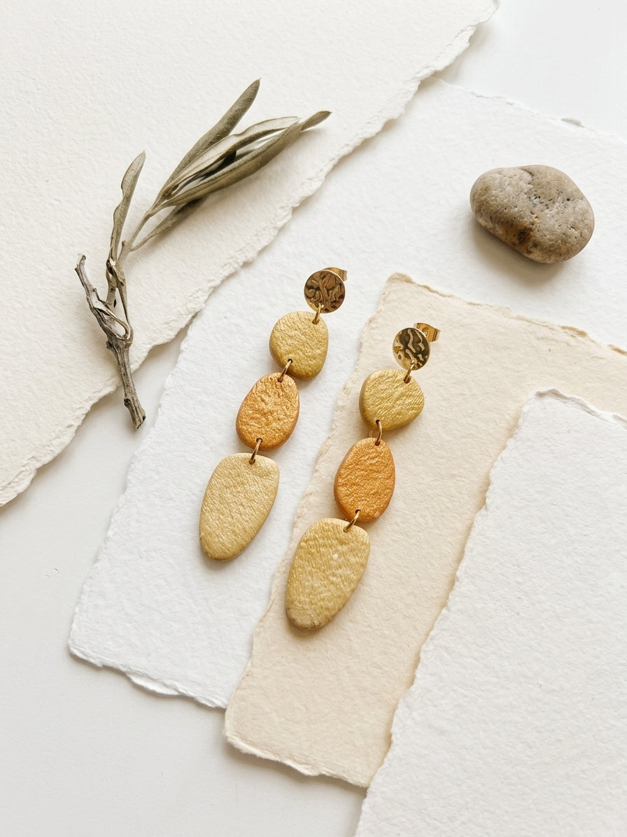 Handmade polymer clay drop earrings in hammered gold and amber tones — Mariamné